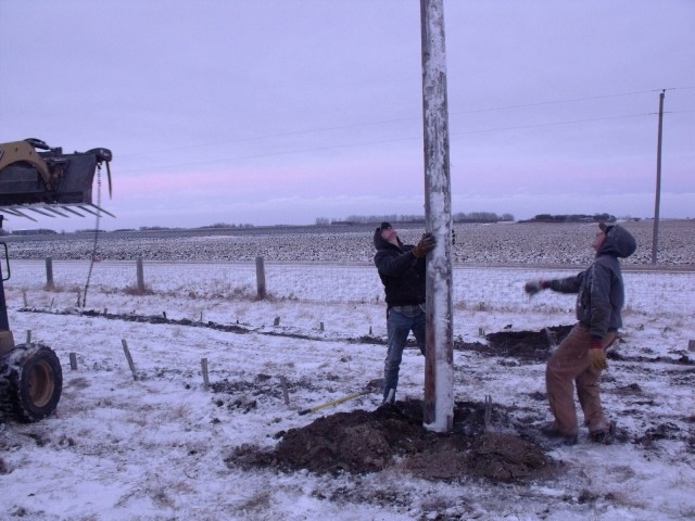 Clayton and Caleb straighten an REA pole that will be used to hold up our Hops plants.