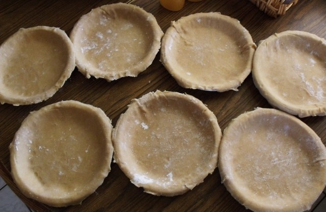 Pie crusts ready to be filled with the apples.
