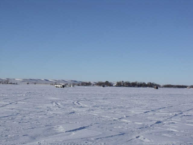 Taking in the view of the other ice houses as we drove up to our fishing spot. See the lovely hills in the background.