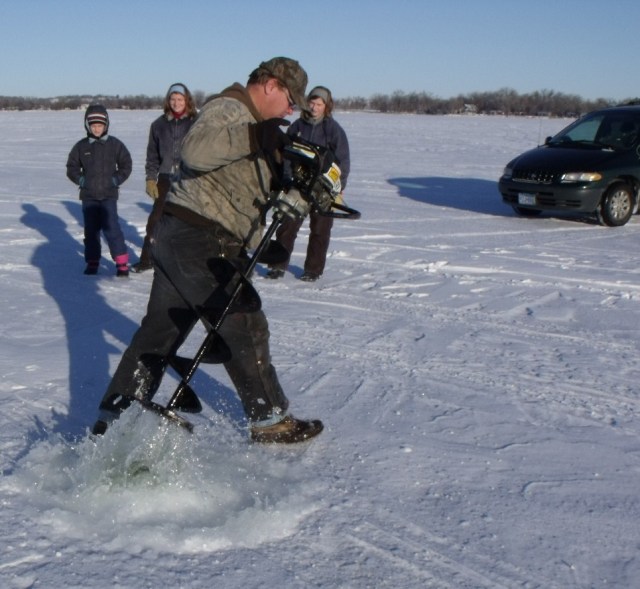Don digging one of the ice fishing holes.  See the water come splashing out!