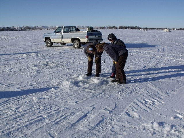 It's really something to peer down into a freshly dug hole in a deep, dark, frozen lake.