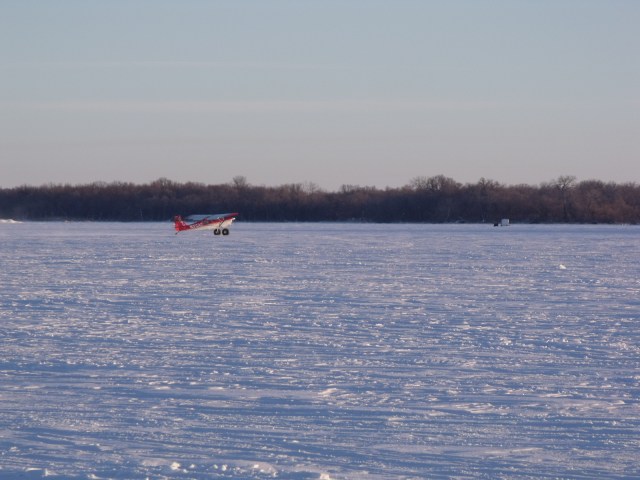 A small plane landed on the frozen Minnesota/South Dakota border lake to take in some ice fishing.  