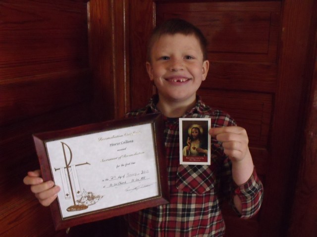 Mario with his certificate and the holy card given to him by Father Craig Timmerman.