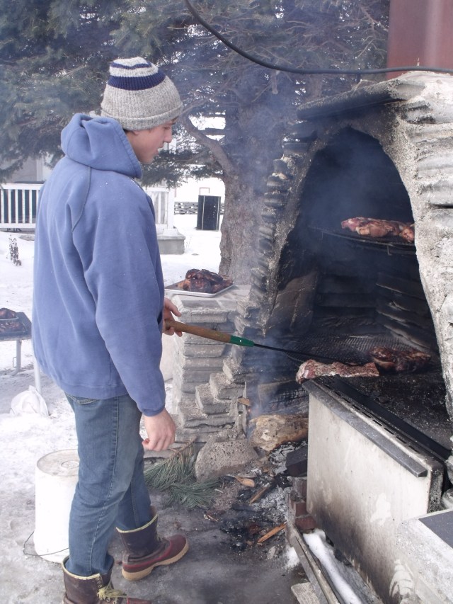 Caleb smoking the bacon and hams from the hog we processed recently.
