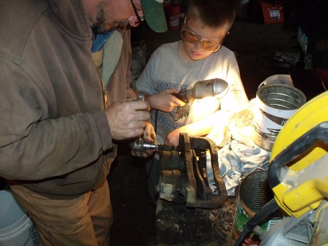 Father and son, fixing the brakes....what a great place here on the farm for boys to learn hands on.