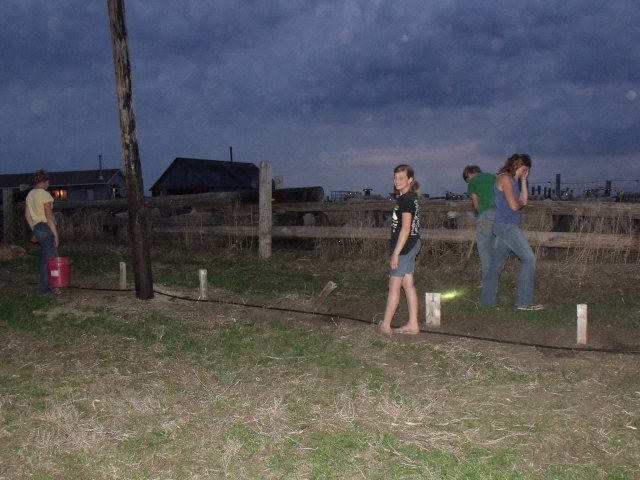 Hurrying to plant the grass seed before the rain last night.