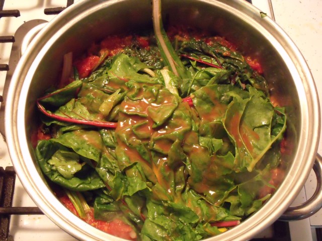 Swiss Chard in Marinara Sauce!  Fry 3 garlic cloves and brown lightly in olive oil.  Throw in crushed tomatoes, salt, papper and sweet basil.  After it boils drop in a few leaves of swiss chard at a time until they shrink down in size. Simmer, add Red Hot sauce if you like and either eat as a soup or serve over any kind of pasta.
