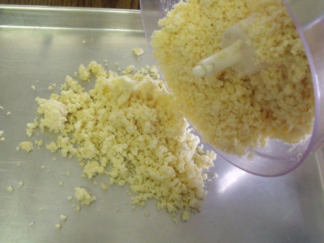 The ground cheese is poured on to a cookie tray to dry out for about a week.
