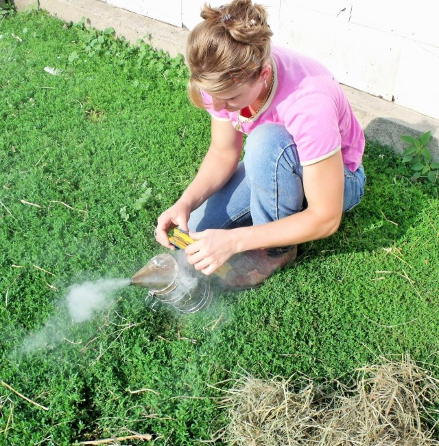 Marisa prepares the smoker using hay which we kept going for awhile.
