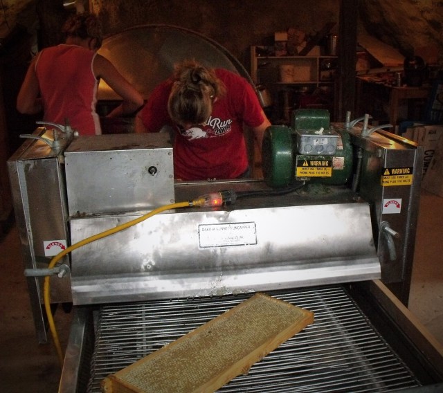 The frame of honey enters the machine.