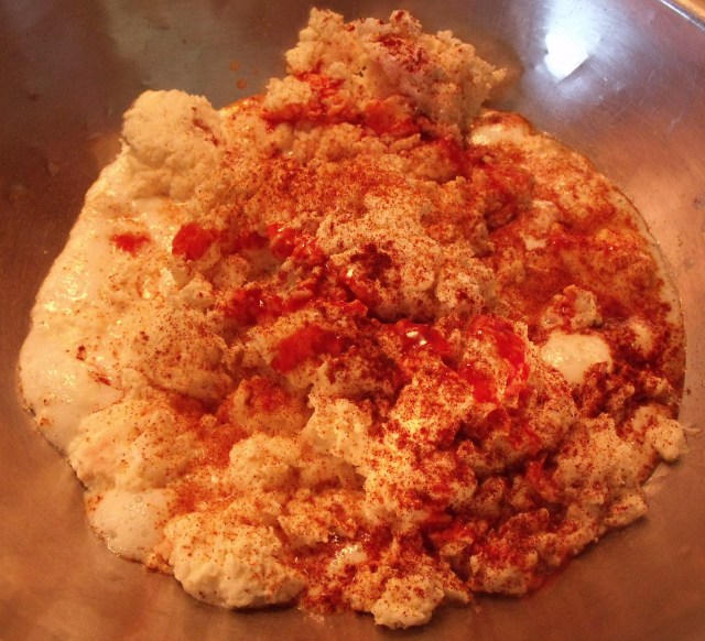 One of my batches of cheese as it is starting to melt and bubble.  The red liquid is hot sauce for this particular batch.