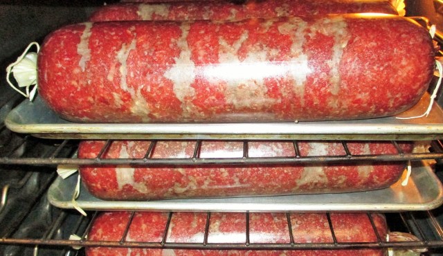 Summer sausage in the oven before Fred built the smoker.