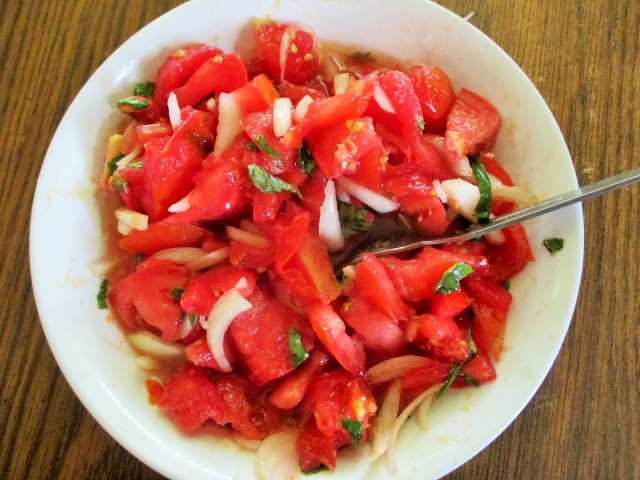 Great crop of early tomatoes. We eat this salad at least one meal a day. Tomatoes, sweet onions, sweet basil, salt, garlic, garlic and more garlic, drizzle with olive oil. YUM Some like cucumbers or green peppers in this as well.