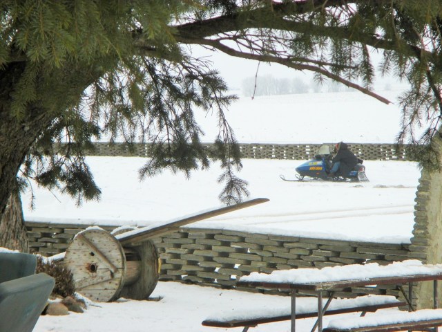 Sandra and grandson Blasé on Calebs snowmobile. 