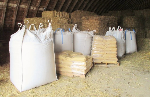 Organic feed for the hogs stays dry in the Quonset.